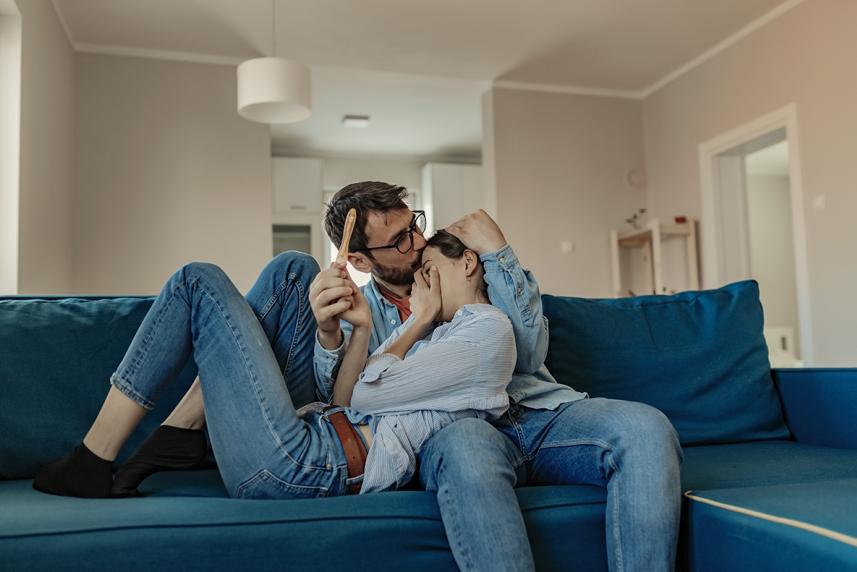 Couple cuddling on couch