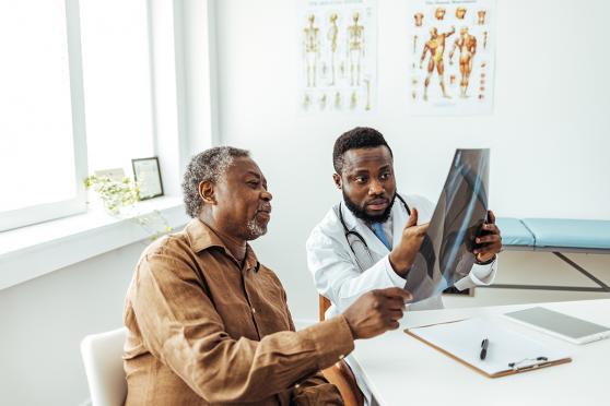 Man going over test results with doctor.
